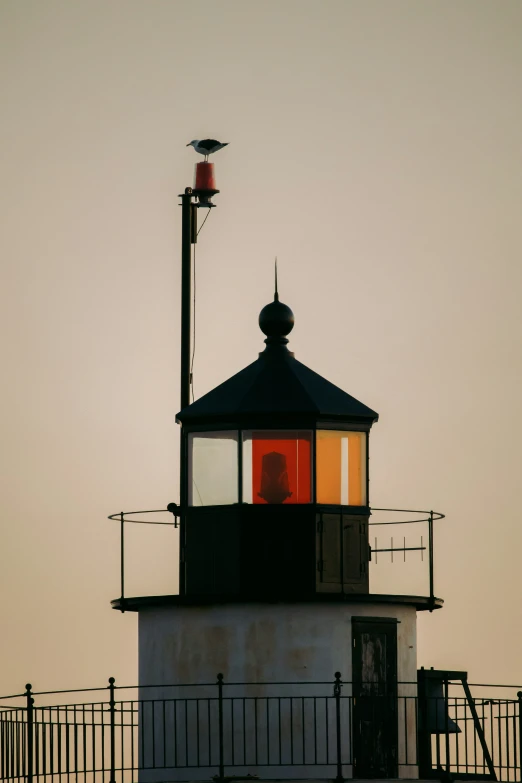 a lighthouse sits on top of some metal railings