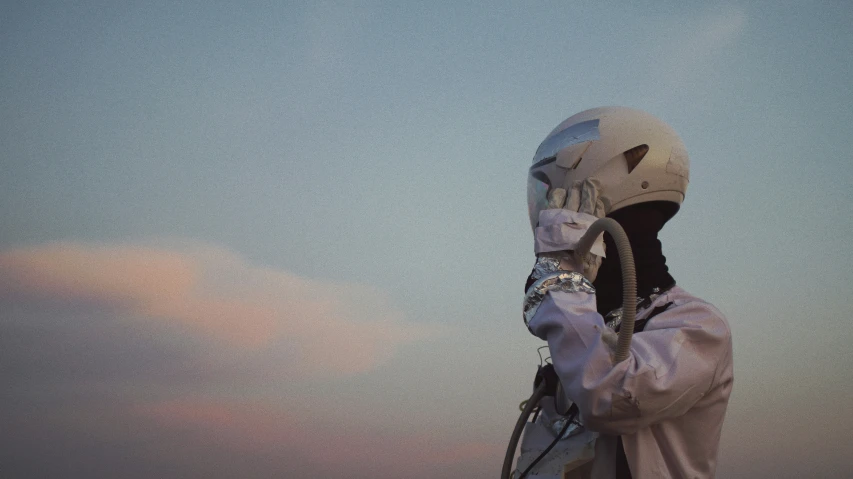 a man with a white jacket and helmet covering his face