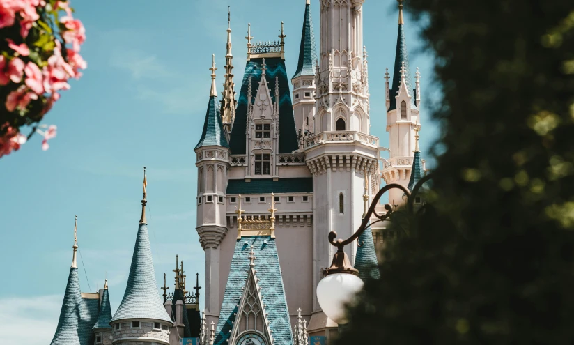 a castle with large towers is seen through some trees