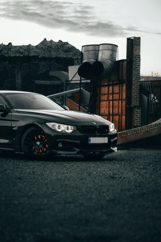 a black car parked on a lot in front of a building