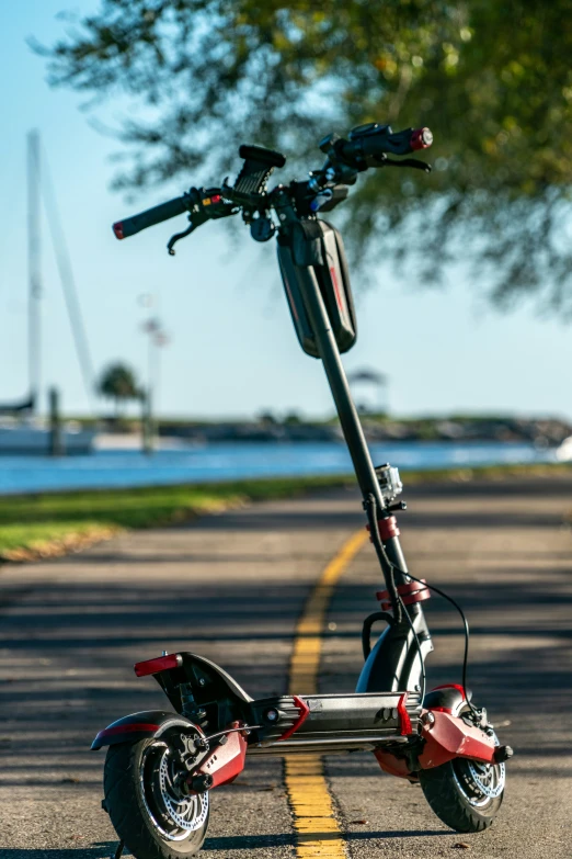 a red scooter is parked on the street