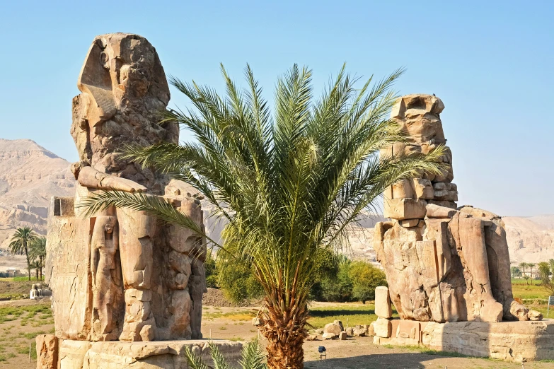 two large statues with large heads are on display