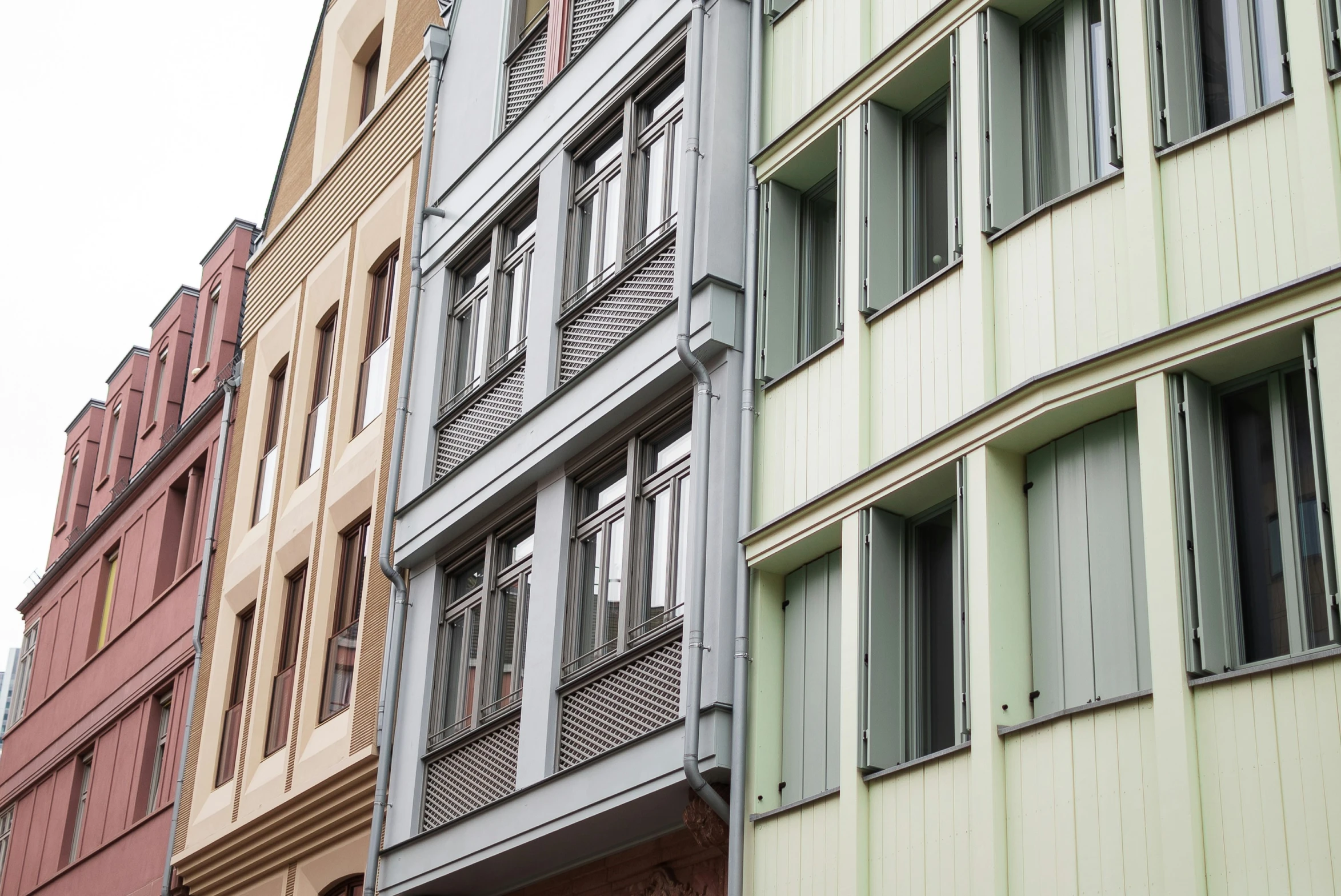 four different colored buildings with many windows on each side