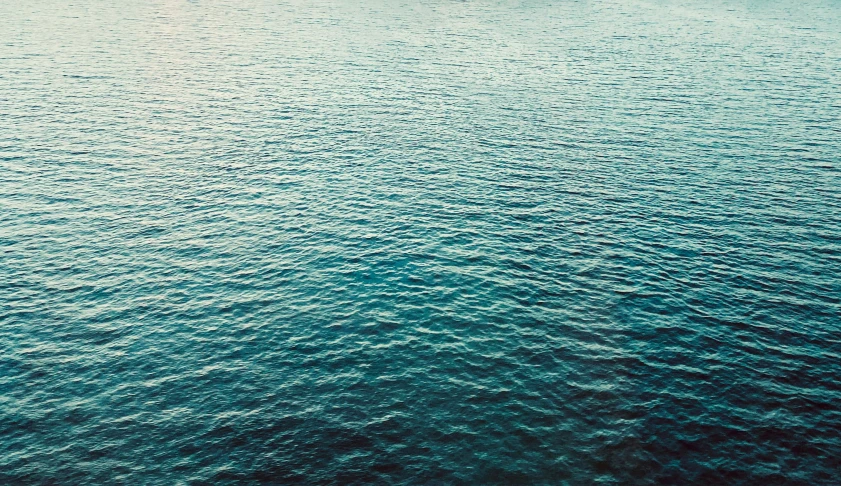 blue water that is in the middle of a body of water