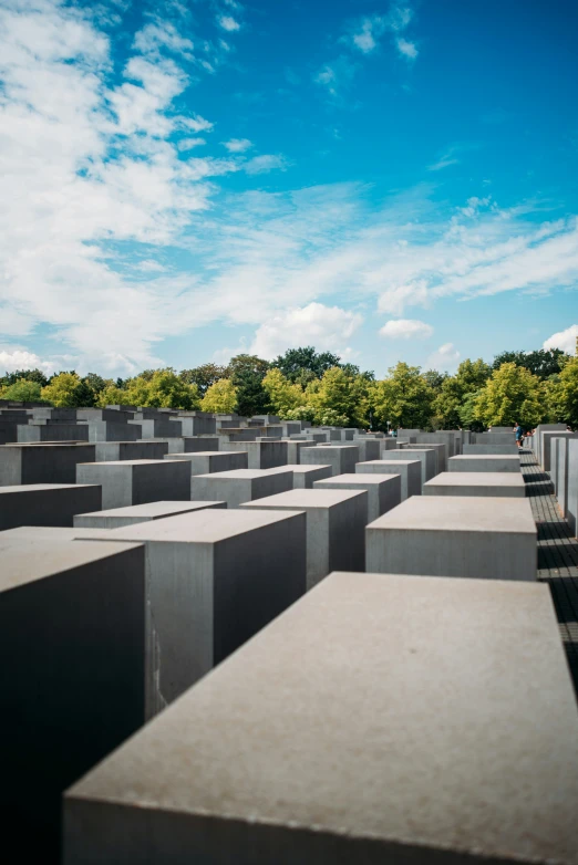 a sky is behind a row of grey concrete slabs