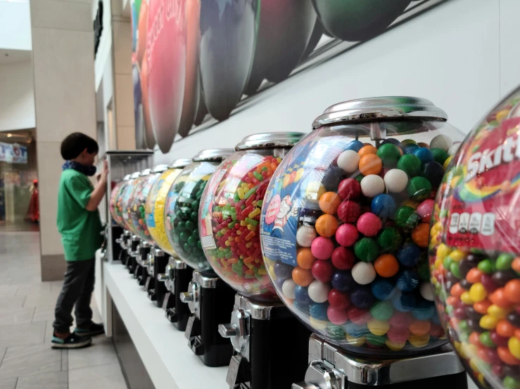 a child is playing in a candy machine