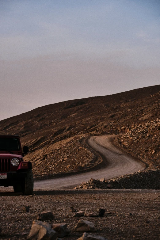 a jeep is on the side of a road in the desert