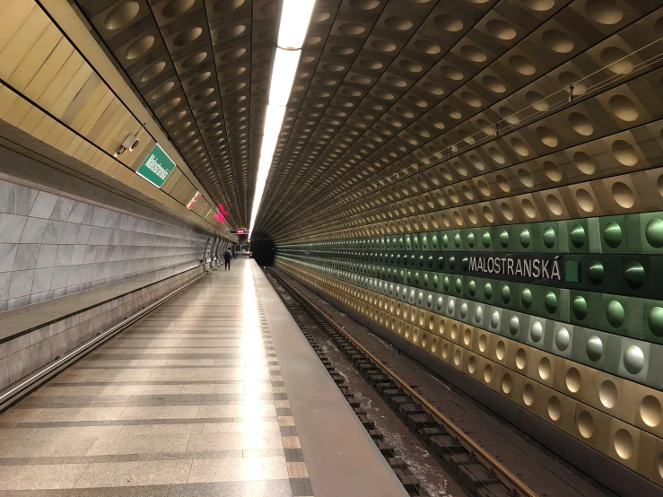 the interior of a subway in the city, with tracks and lights