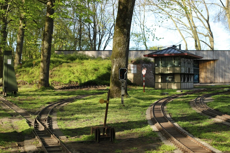 train tracks next to building and trees