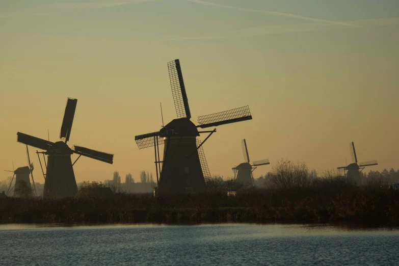 a bunch of windmills sitting on top of a field