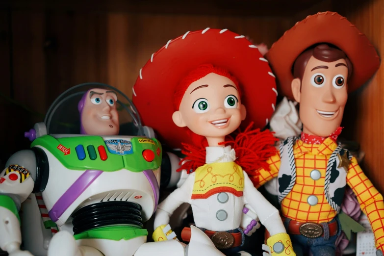 two toy buzzwakers sit next to a buzz and woody action figure