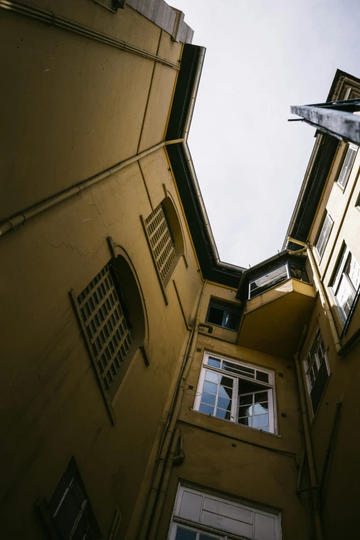 a tall building with multiple windows and shutters