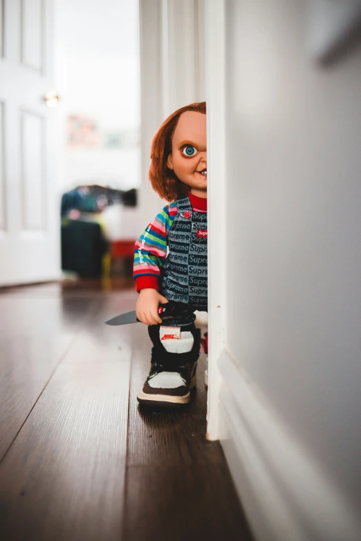 small doll holding onto a string on the ground