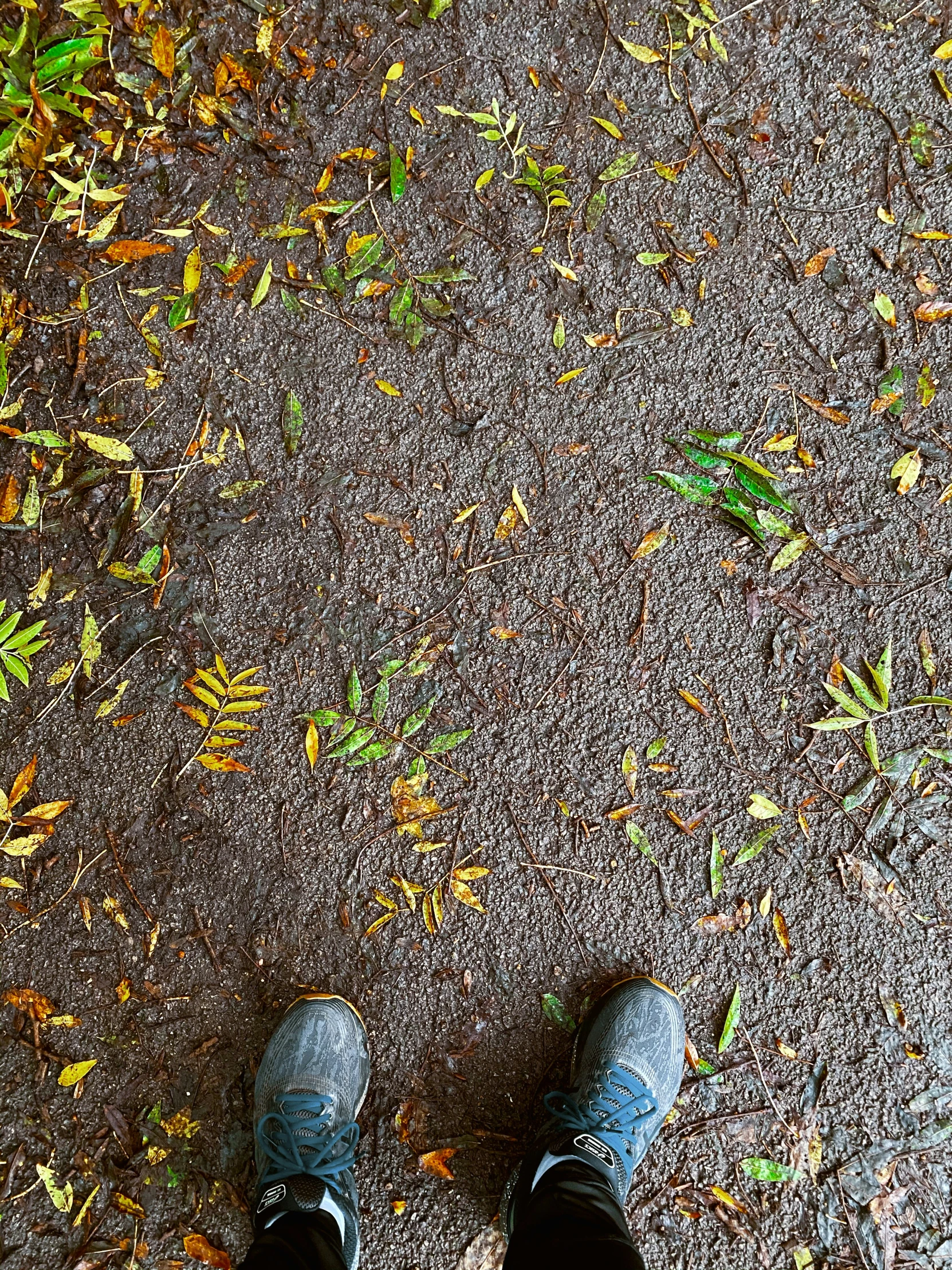 a person is standing in the street with their feet up