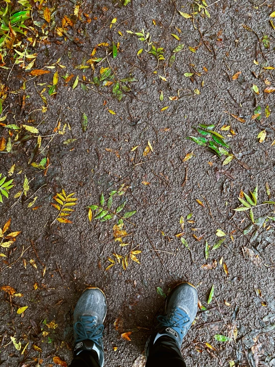 a person is standing in the street with their feet up