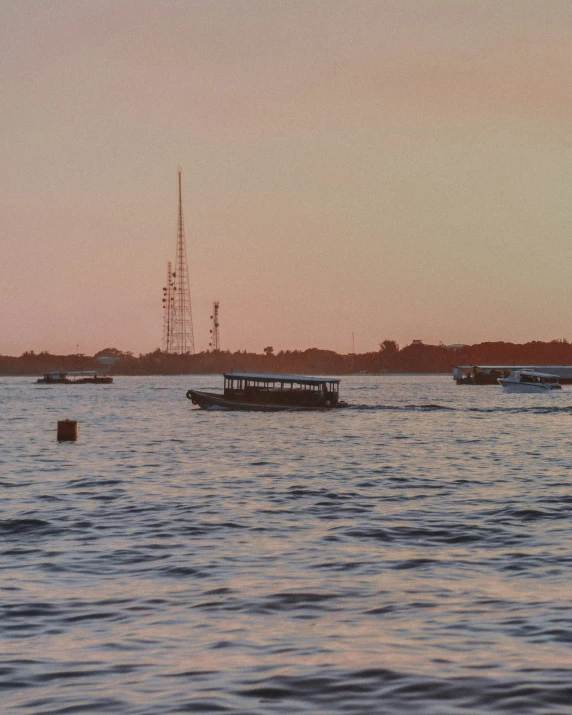 a boat in the water and boats floating by in the distance