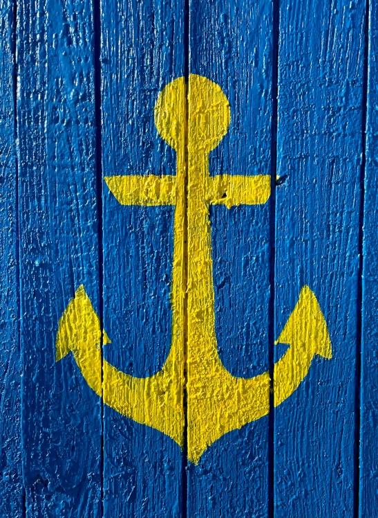 the image has an anchor painted on the boards