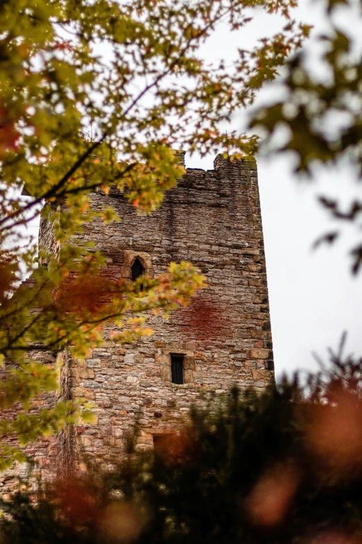 a stone building that is surrounded by trees