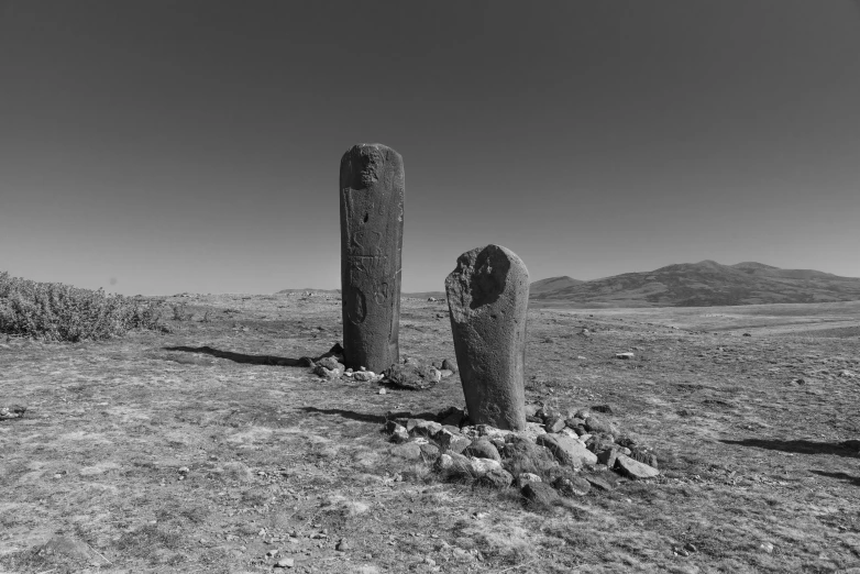 an area with hills and grass, covered in small rocks