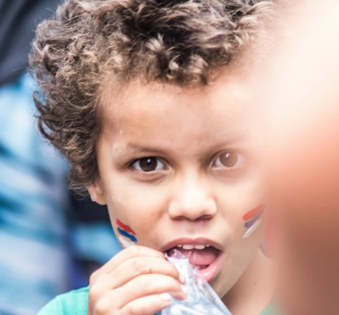 a little boy holding onto to a plastic bag