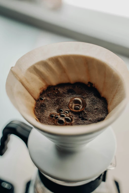 a cup of coffee is on top of a stove burner