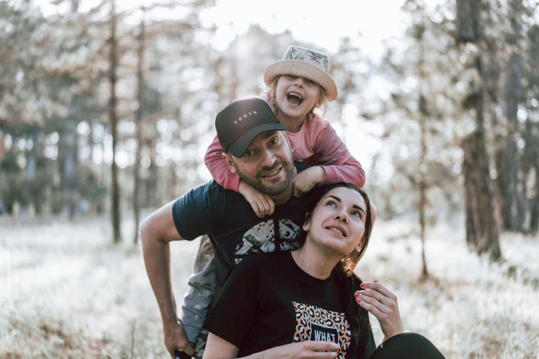 a man holding his child on the shoulder while he holds her