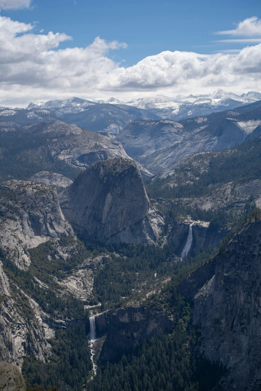 a rocky mountain valley with waterfall and water fall