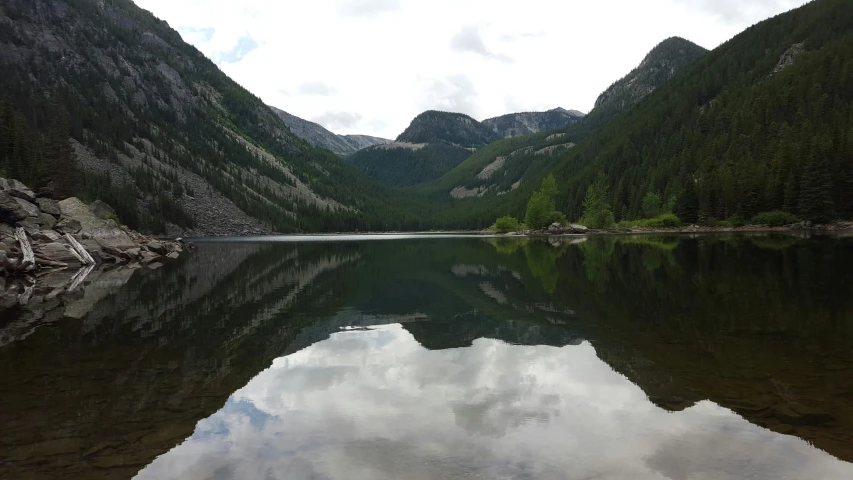 some mountains are reflected in the water