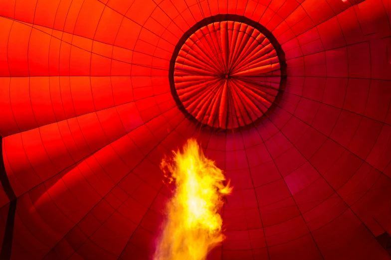 a bright orange fire inside a red  air balloon