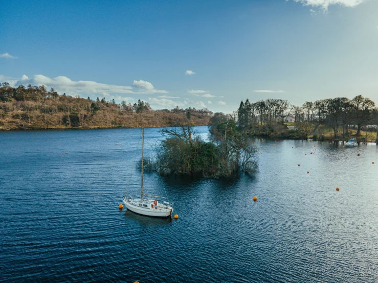 small sailboat on a lake with small islands