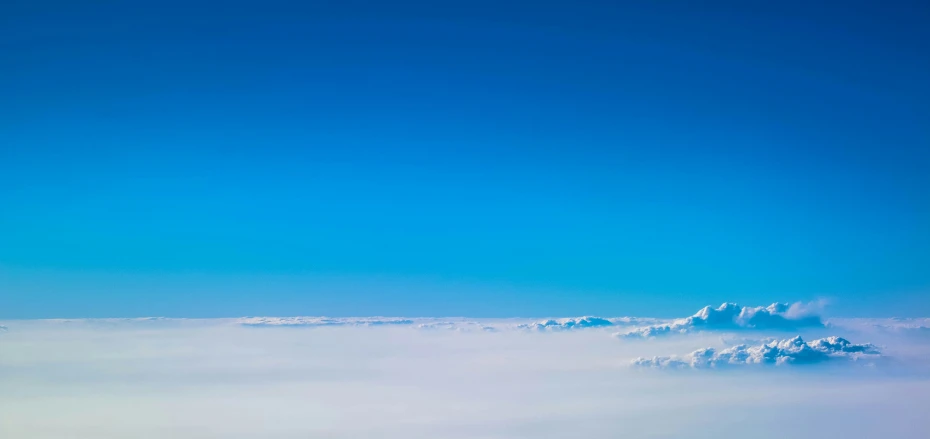 a very blue sky filled with clouds under a few clouds