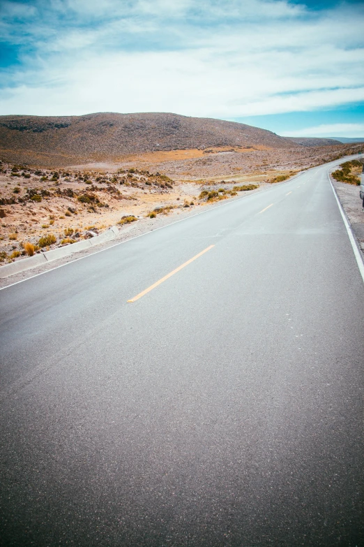 a car is on the side of a wide highway