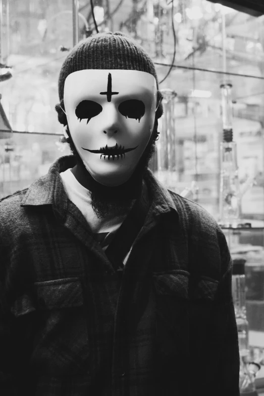 a person wearing a mask with cross painted on it