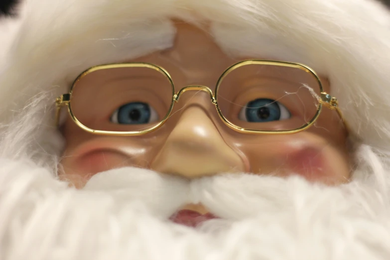 a santa doll's nose wearing glasses and a wig