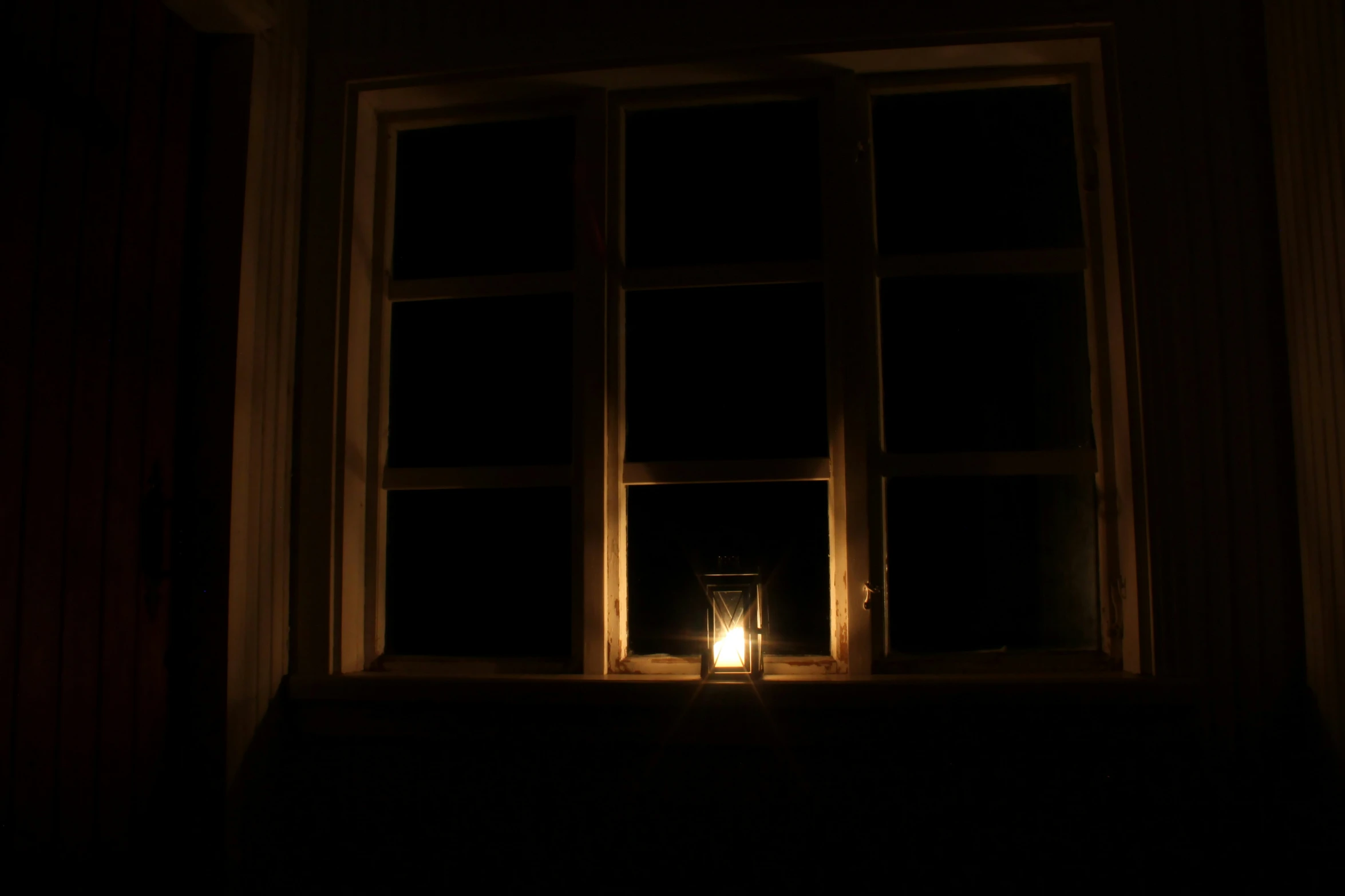 a candle that is sitting in front of a window