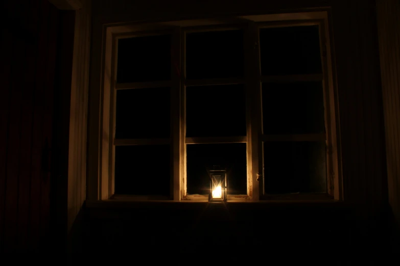 a candle that is sitting in front of a window