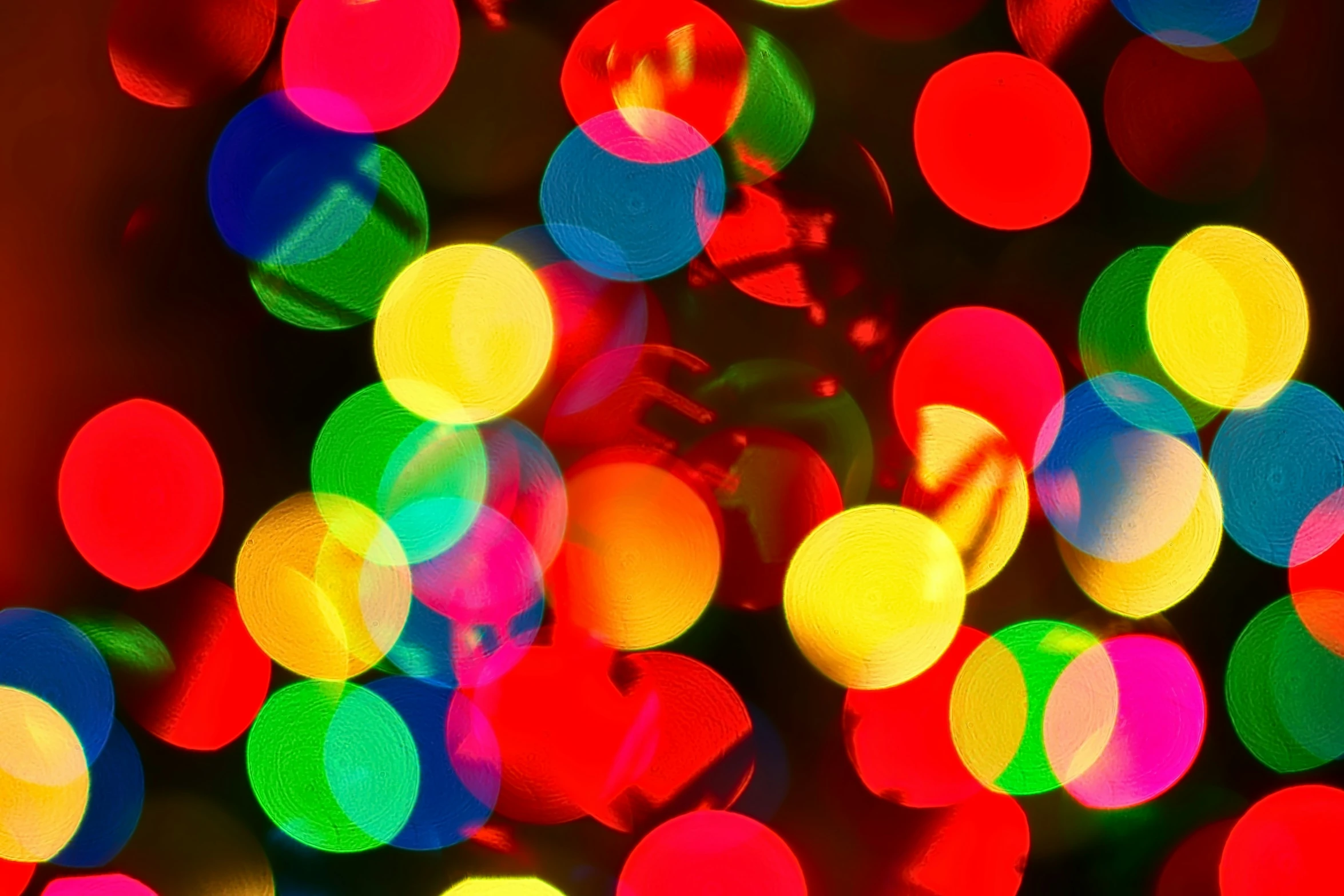 a christmas tree with colorful lights in front of it