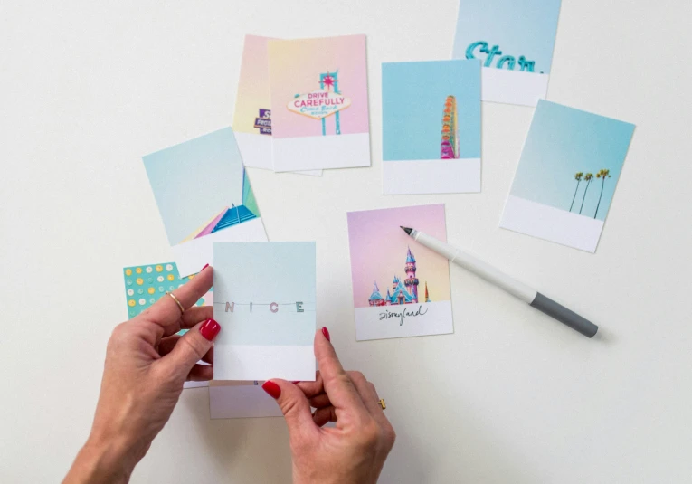 the person is working on some small greeting cards