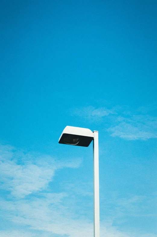 the top of a streetlight with a blue sky in the background