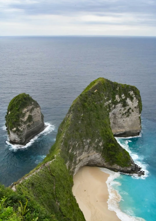 three small rock formations on the coast in the ocean