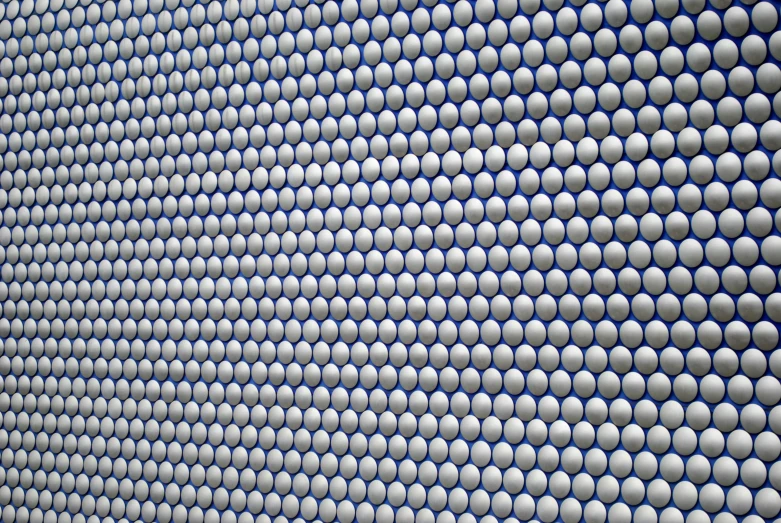 a blue and white wall with white dots on it