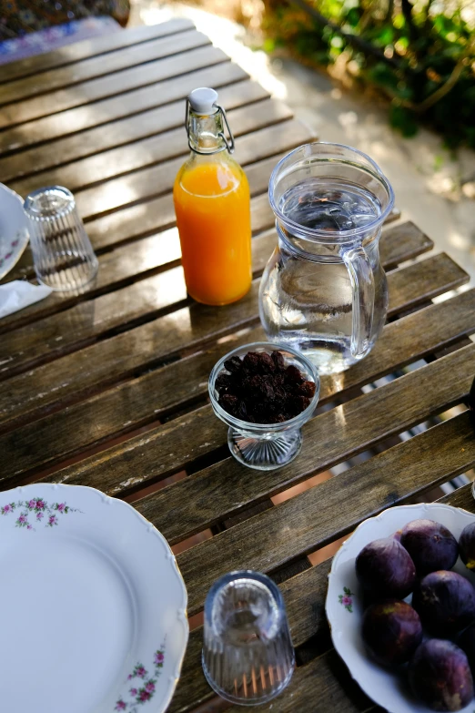 a meal setting on a wooden table outdoors