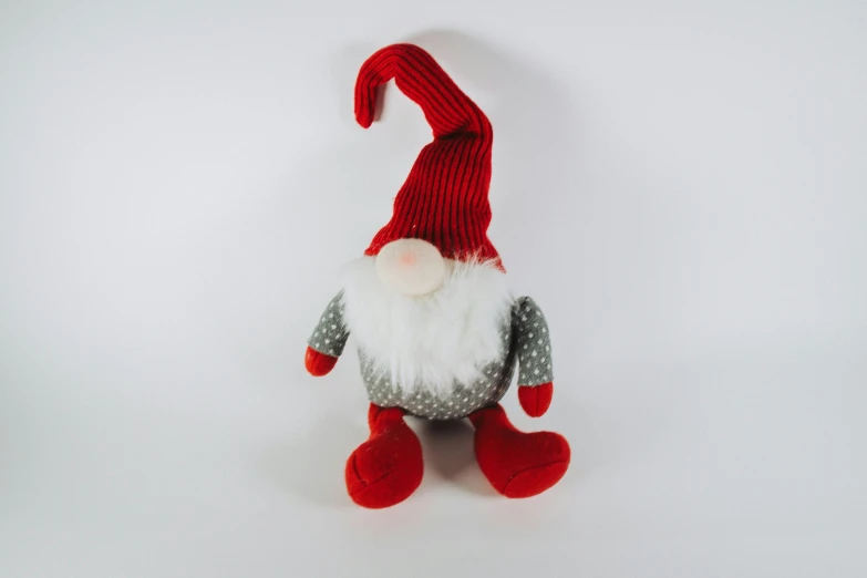 a handmade gnome with gray and white hair and a red nose