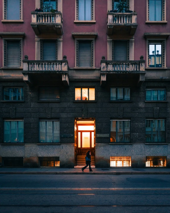 an older man walking into the doorway of a large building