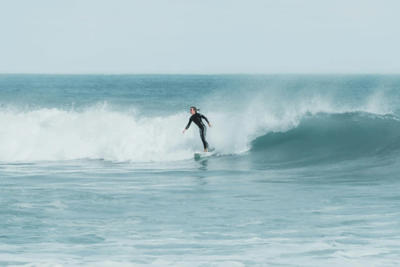 a man is riding on a wave in the ocean