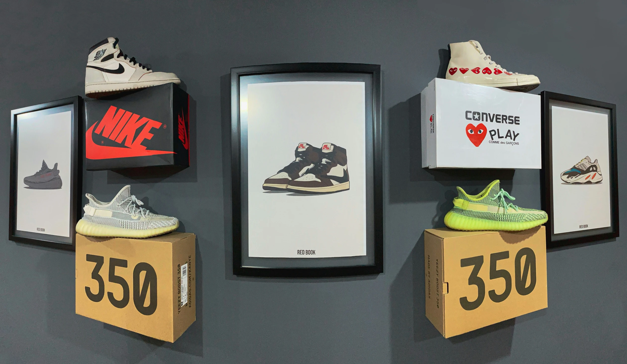 three boxes sit stacked on top of a shoe display, holding shoes and price tags