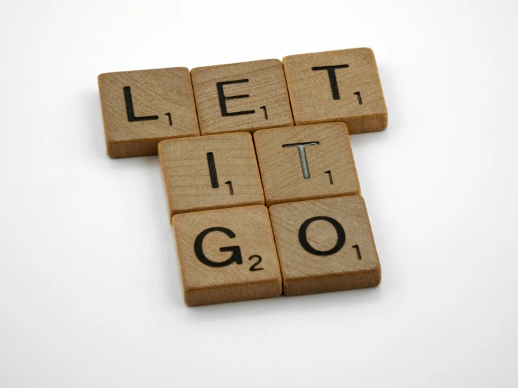 a close up of a scrabbled word with the words let it go