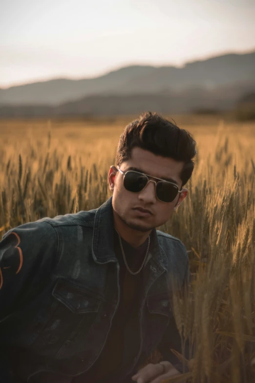a person wearing sunglasses in a field