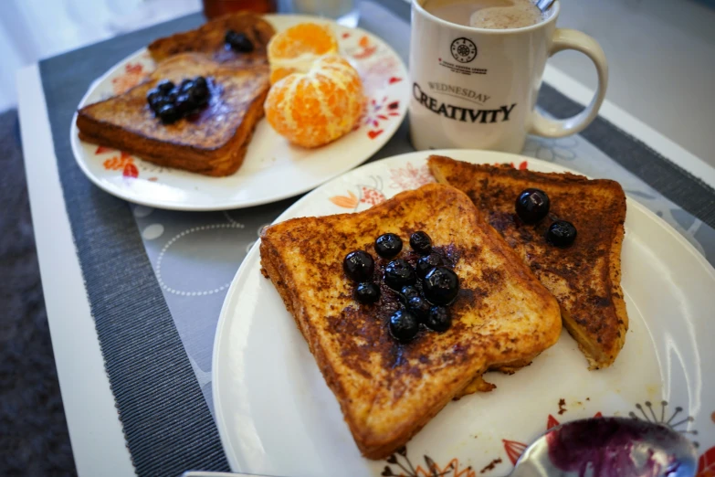 grilled cheese sandwiches served with black olives on white plates