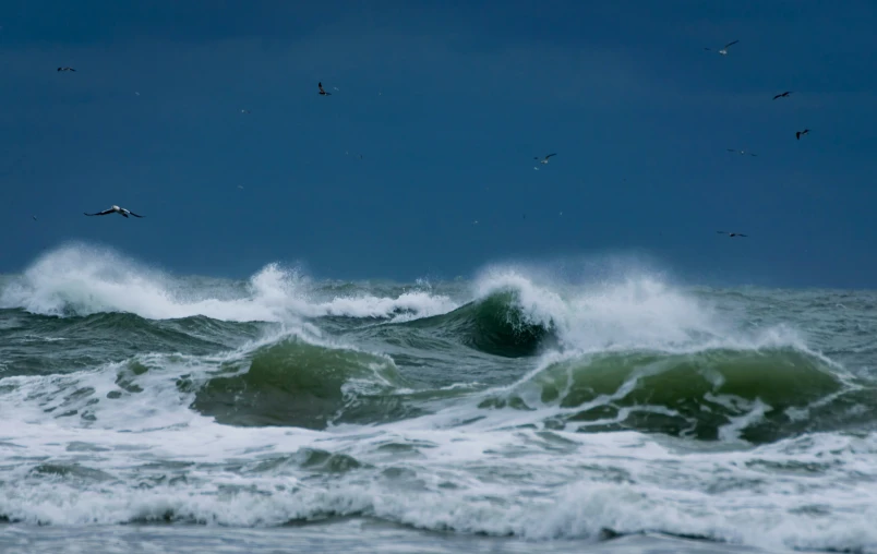 large waves are crashing on to a shore line